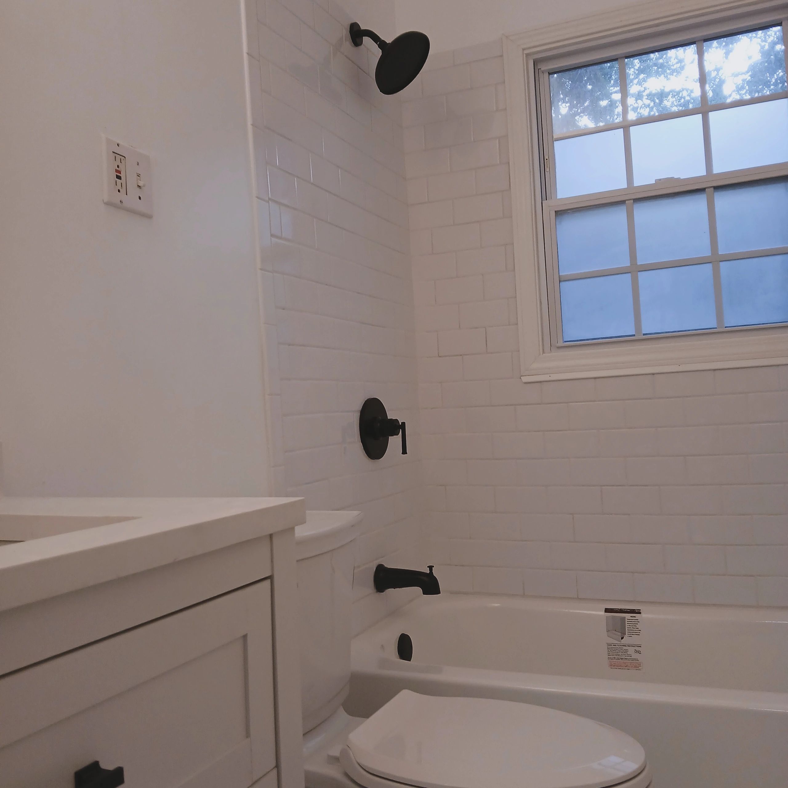Bathroom renovation with bathtub and white tile