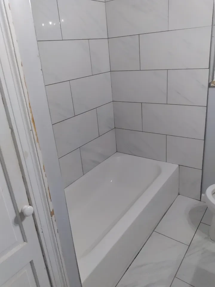 Bathroom with white subway tile and bathtub