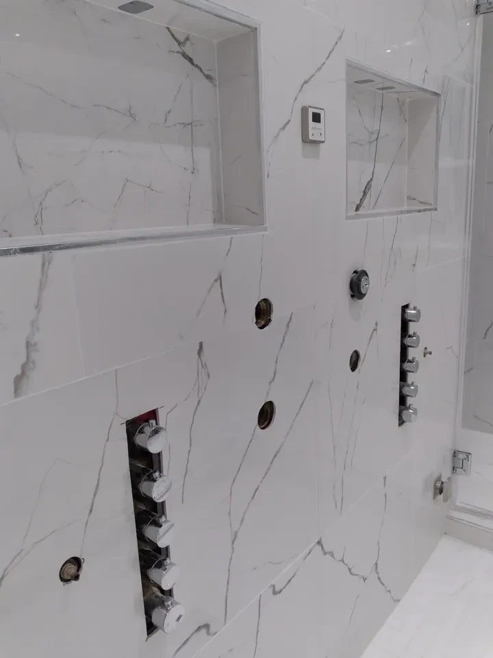Marble bathroom wall with chrome fixtures